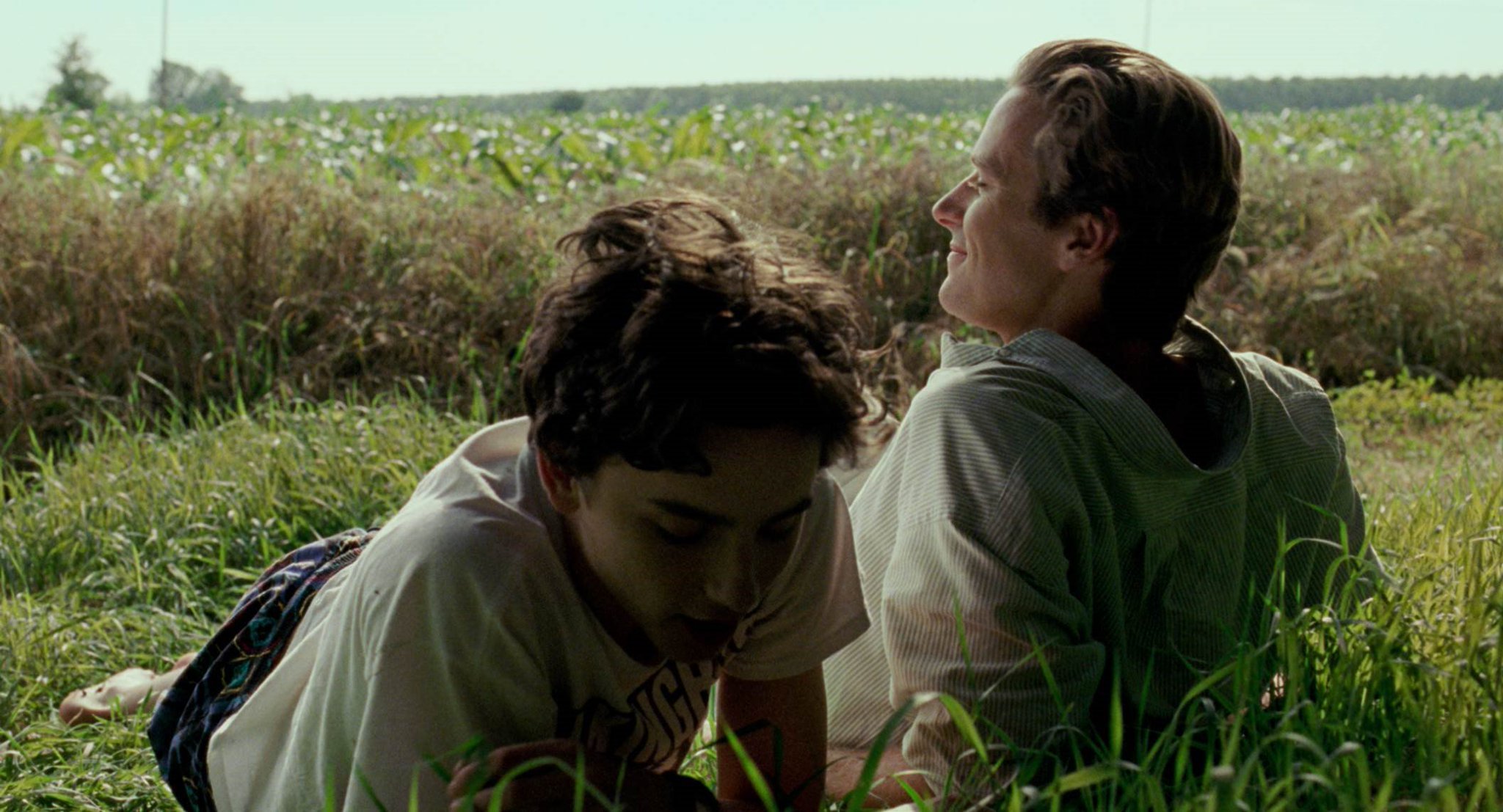 Elio and Oliver laying in the grass